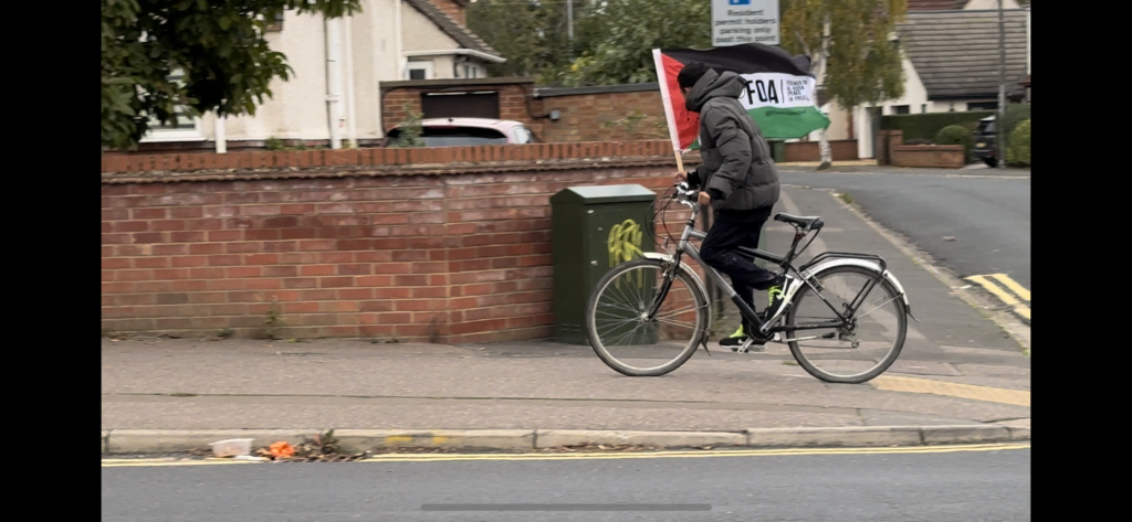 The cyclist was spotted in Stanground riding up and down the streets with a Friends of Al-Aqsa (FOA) flag held high. 