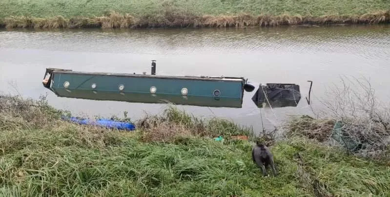 Abadon ship! The boat that came adrift from its unofficial mooring on the river at March and overturned. PHOTO: CambsNews
