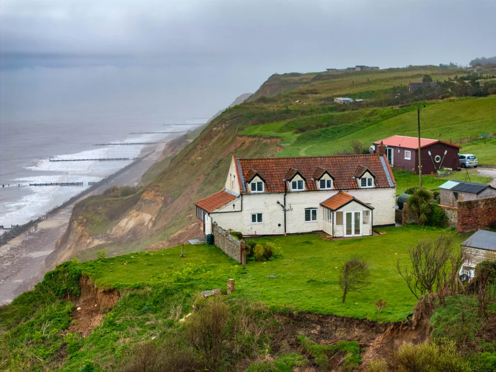 WATCH: 18th century Norfolk farmhouse left dangling over a cliff edge