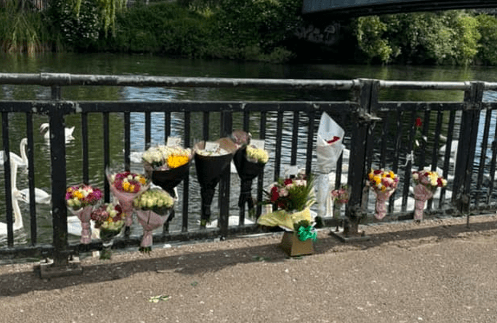 Flowers left on Peterborough town bridge after a man drowned after he jumped into the River Nene to escape police. 