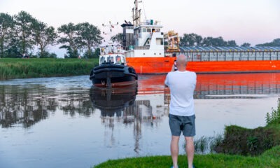 Spectators gathered by the River Nene in Wisbech as the Baltic Arrow, with its cargo of timber from Latvia, was finally freed and pulled into port. PHOTO: Terry Harris