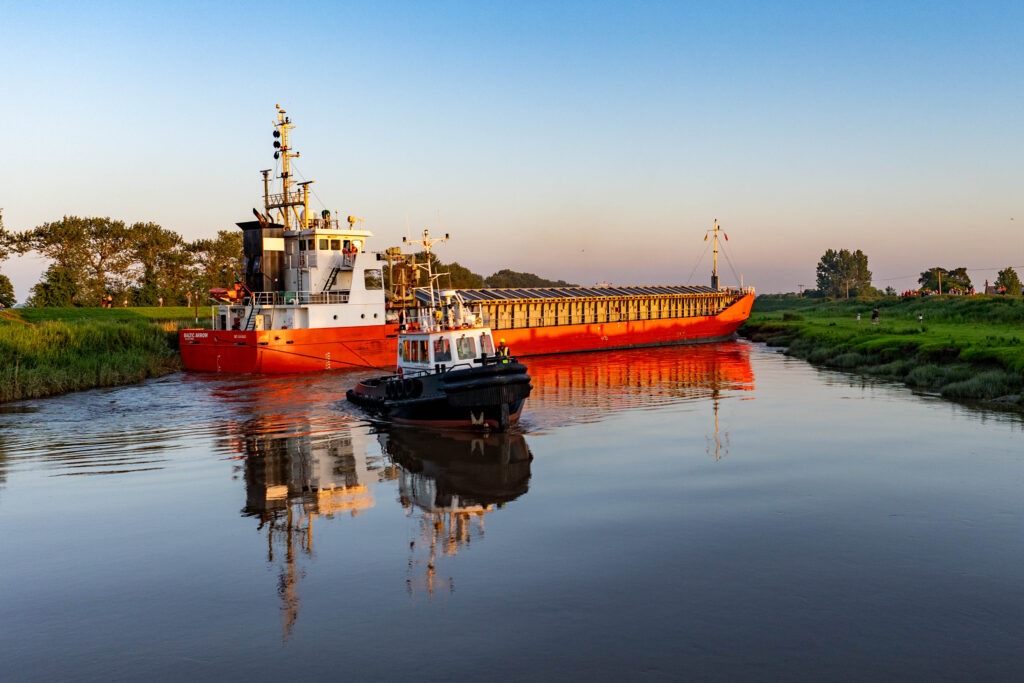 Spectators gathered by the River Nene in Wisbech as the Baltic Arrow, with its cargo of timber from Latvia, was finally freed and pulled into port. PHOTO: Terry Harris 