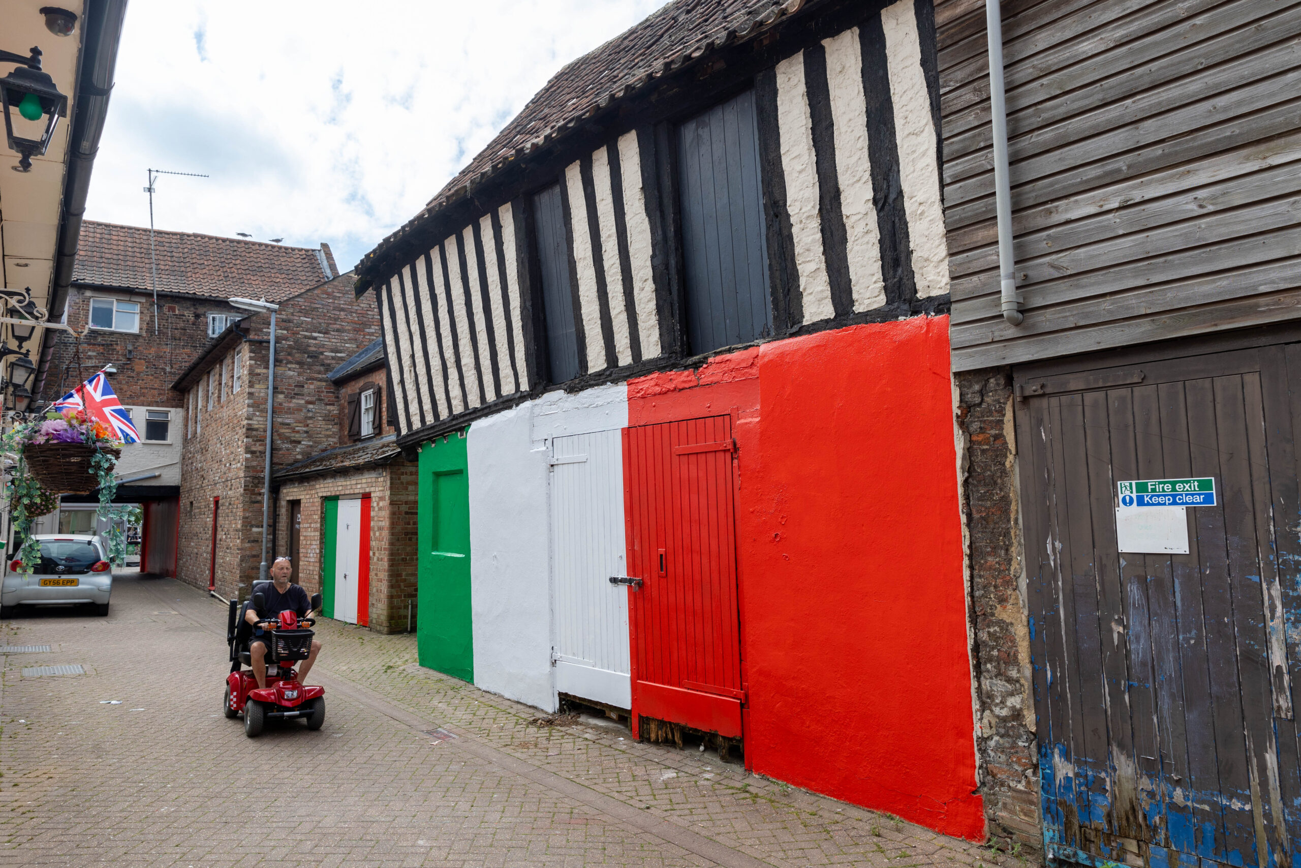 Wisbech town councillor Shahid Rafique facing an outcry after he painted a 15th century listed building red, white and green – to match the colours of his Italian Affairs restaurant