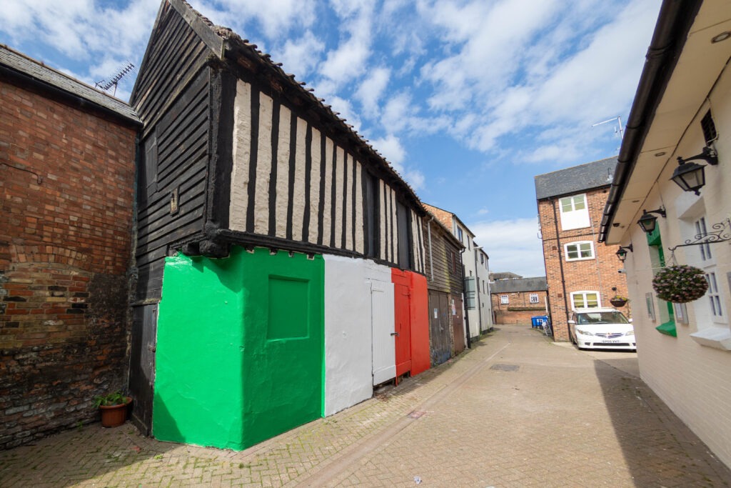 Wisbech town councillor Shahid Rafique facing an outcry after he painted a 15th century listed building red, white and green – to match the colours of his Italian Affairs restaurant 