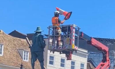 Workman removes the traffic cone from the statue of Oliver Cromwell in St Ives