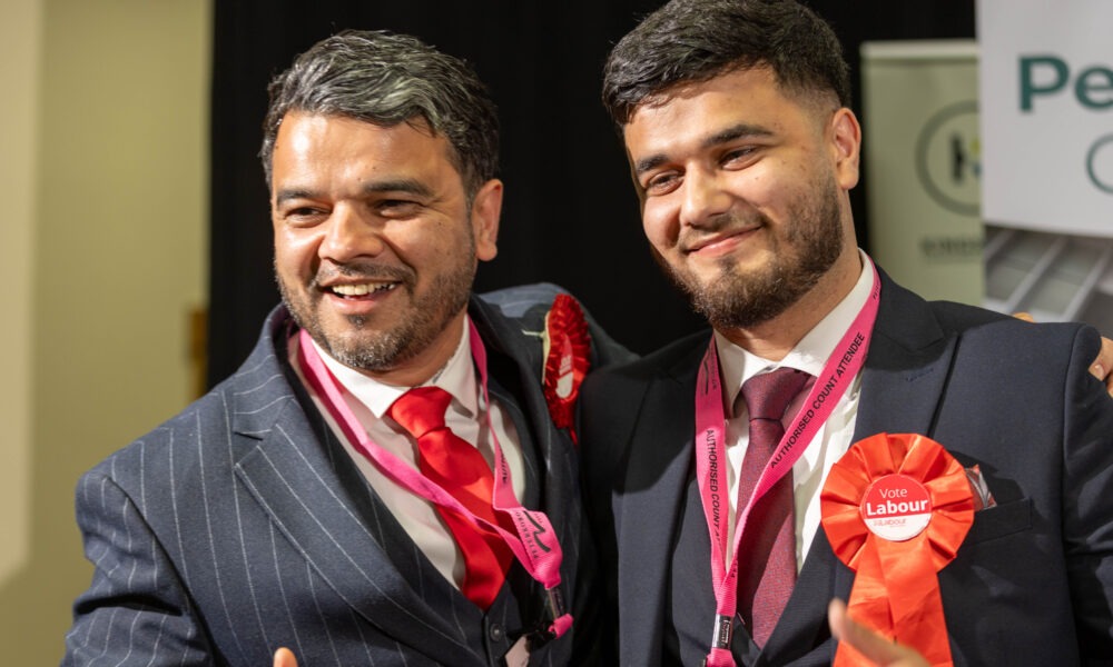 Councillor Amjad Iqbal (left) celebrating his election success in May PHOTO: Terry Harris