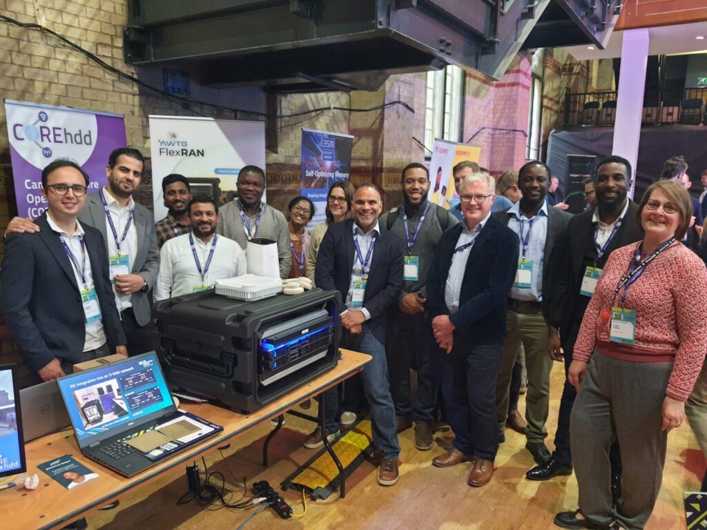 The Core project at Cambridge Tech Week 2024, Innovation Alley. L-R: Hamidreza Taghvaee (Uni of Surrey), Ali Ali (Uni of Surrey), Deepkumar Mada (AWTG), Sandeep Kumar (AWTG), Chidi Williams Ohiagbaji (AWTG), Anjali Nair (AWTG), Cristina Delgado Gomez(AWTG), Navin Sankersingh (Connecting Cambridgeshire), Marvin Kelly (AWTG, Michael Stevens (Connecting Cambridgeshire), Andrew Thomas (Benetel), Omar Gaye (AWTG), David Mintah (AWTG), Valerie Jackson (Wolfram).