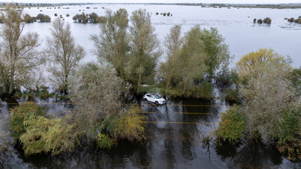 Picture dated October 10th shows the abandoned car on the flooded A1101 in Welney on the Norfolk/Cambs border with the driver having to be rescued on Wednesday evening by the fire service. PHOTO: Bav Media 