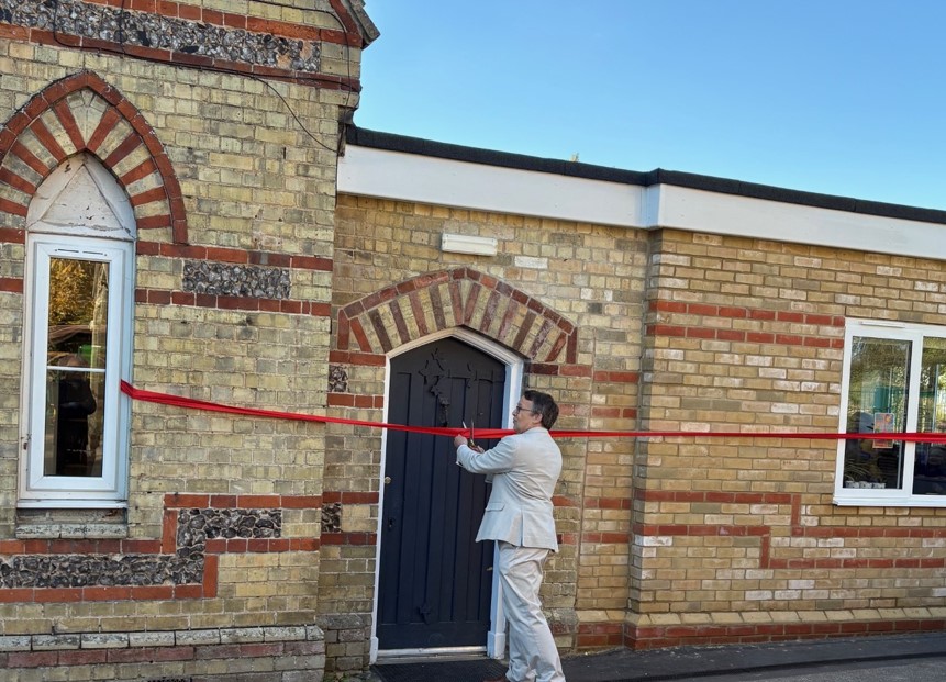 Mark Richer cuts the ribbon as the building is officially opened.