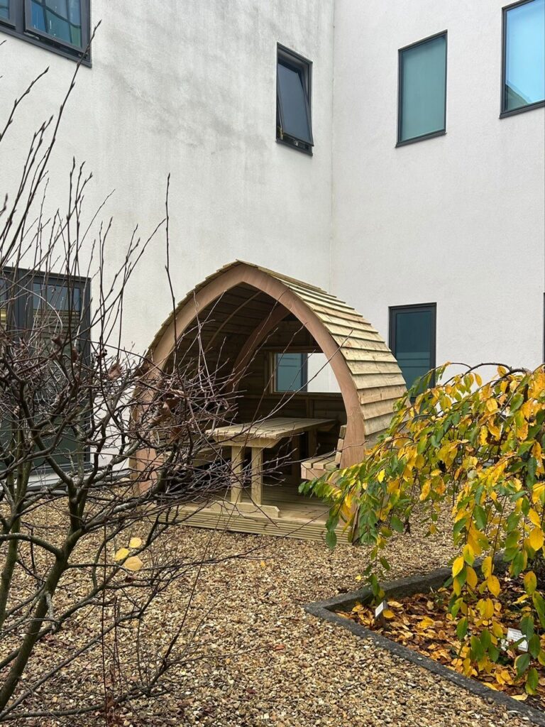 Jennie Grainger – Lead Volunteer Gardener and Staff Reflection Garden designer – with some of the Wood Wizards team installing the pods at Peterborough City Hospital