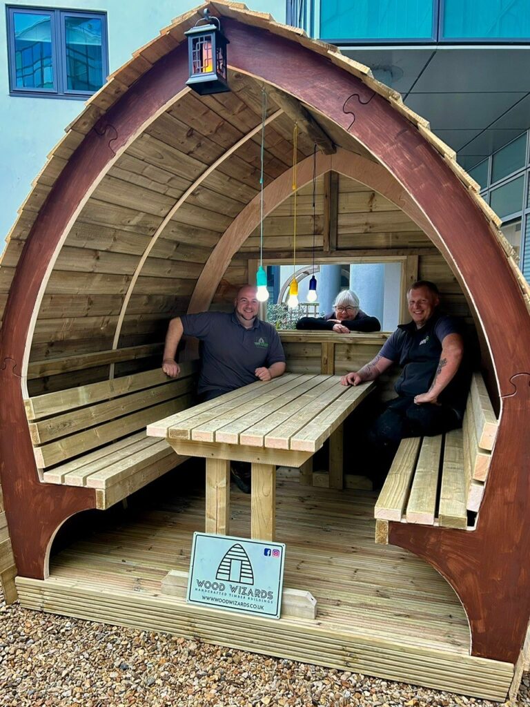 Jennie Grainger – Lead Volunteer Gardener and Staff Reflection Garden designer – with some of the Wood Wizards team installing the pods at Peterborough City Hospital