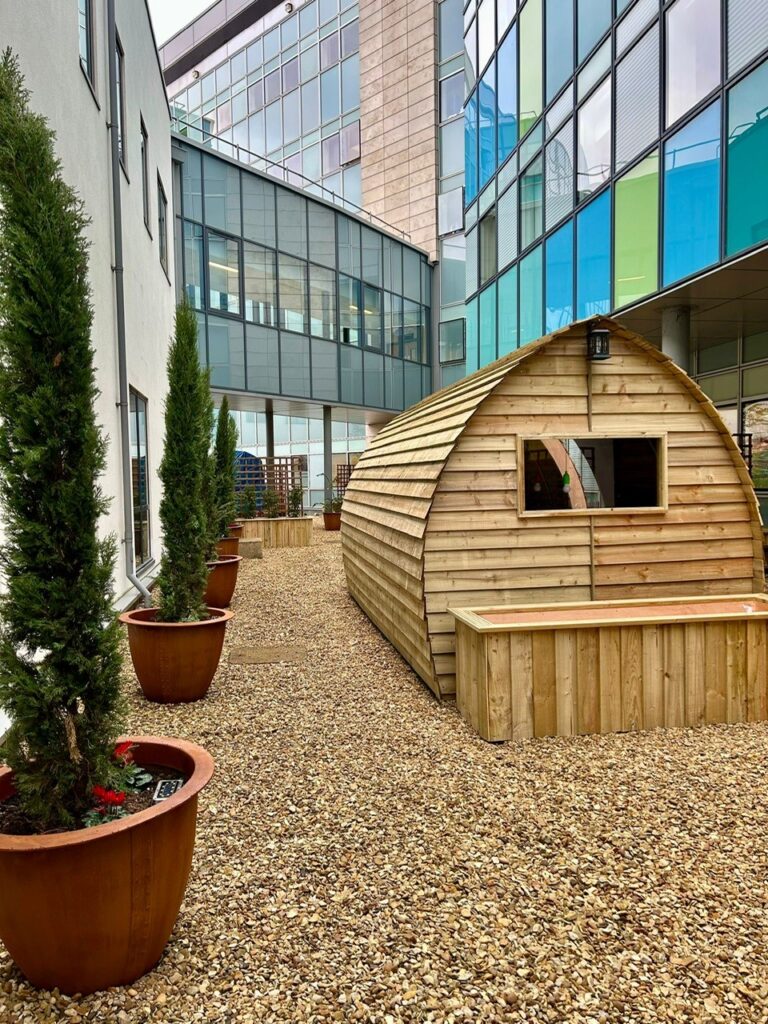 Jennie Grainger – Lead Volunteer Gardener and Staff Reflection Garden designer – with some of the Wood Wizards team installing the pods at Peterborough City Hospital