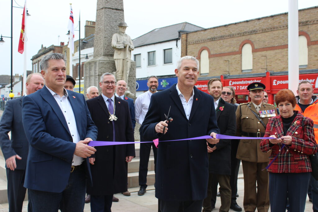 Ribbon cutting: MP Steve Barclay, centre, cuts the ribbon with Cllr Jan French, right, and Jamie Harrison, Delivery Director Highways for Octavius, left, and, in the background, project partner representatives and armed forces representatives, who raised the flags 