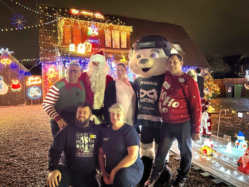 Group photo of the main supporters and guests. (From Top Left: Brian Bell, Santa, Cllr Kirsty Knight, PhamTom, Daryl Ward, From Bottom Left: Benjamin Penton (Sue Ryder), Sharron Toms (Tesco Community Champion 