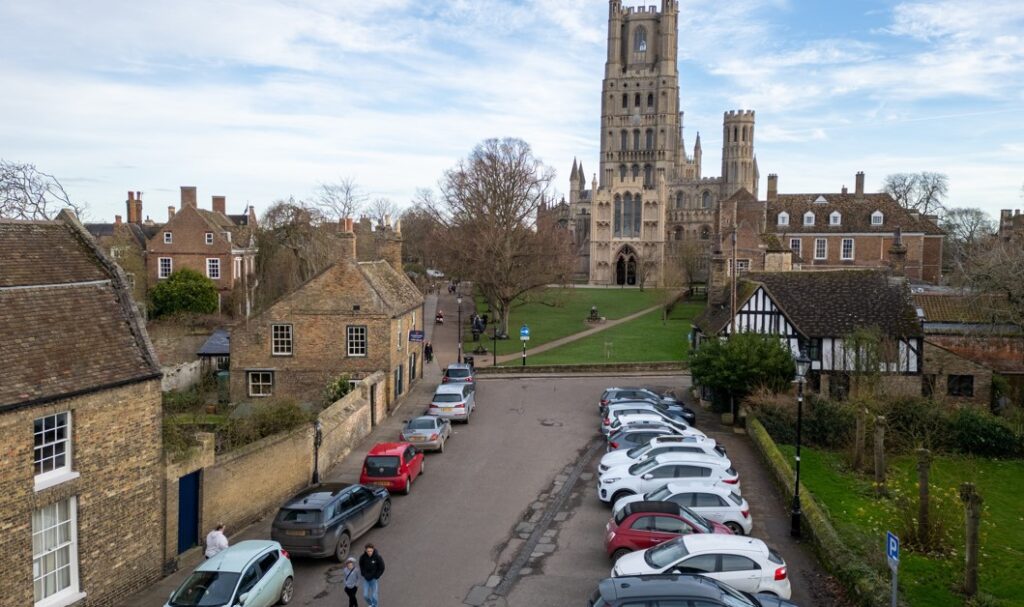 An estate agent has REMOVED a photo from a listing for a Grade II listed house overlooking majestic Ely Cathedral in Cambridgeshire – after admitting it ALTERED the picture to delete the parking bays in front of the cottage. PHOTO: BavMedia 